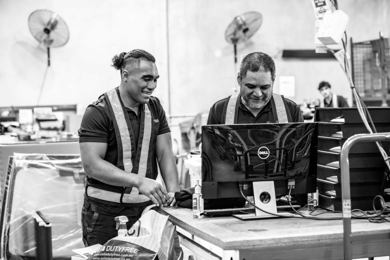 Factory workers at computer
